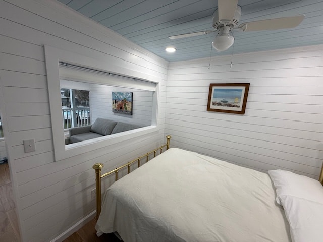 Bright coastal bedroom with brass bed frame, white shiplap walls, powder blue ceiling, and beach artwork at Moxie Girl 1 Atlantic Beach NC