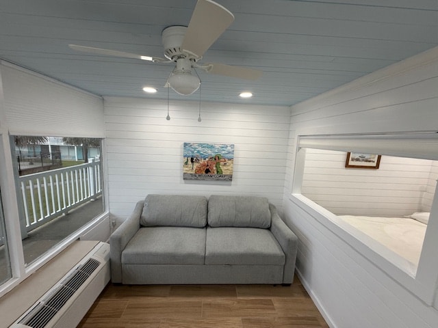 Bright coastal living room interior with white shiplap walls, powder blue ceiling, gray sofa, and beach artwork at Moxie Girl 1 Atlantic Beach NC