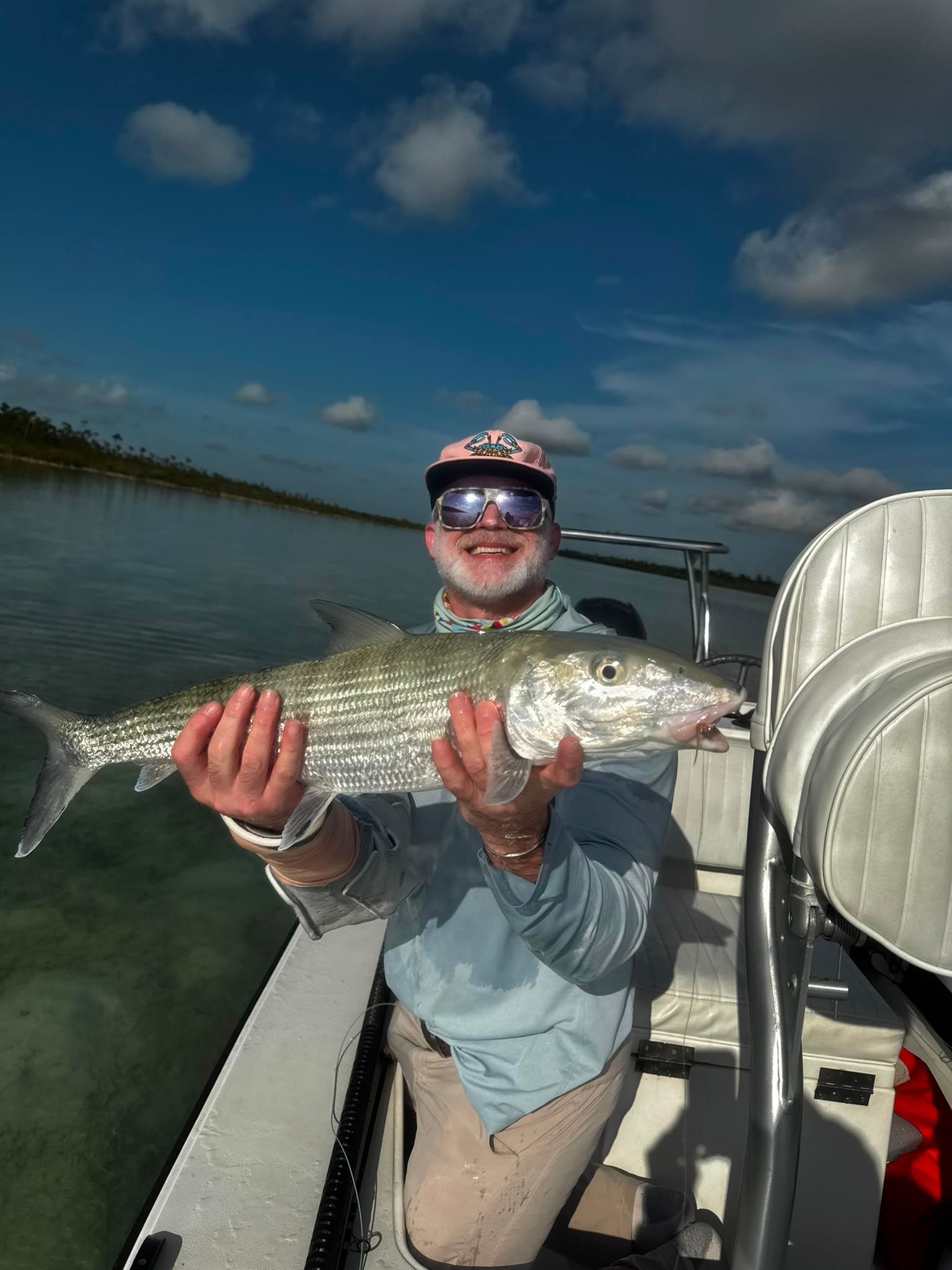 Angler holding up a large bonefish on the Andros flats Bahamas