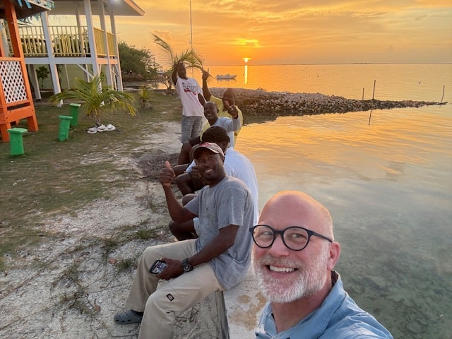 Group of friends at sunset on the water Andros Bahamas